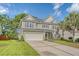 Charming two-story home featuring a manicured lawn, a two-car garage and mature trees, enhancing curb appeal at 5256 Mulholland Dr, Summerville, SC 29485