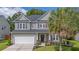 Charming two-story home with a well-manicured lawn, landscaped garden, and a welcoming front entrance at 5256 Mulholland Dr, Summerville, SC 29485
