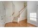 Bright, inviting foyer with hardwood floors, staircase, and a glimpse of the natural light streaming in at 5256 Mulholland Dr, Summerville, SC 29485