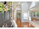 Bright foyer with hardwood floors, staircase, and a view into the dining area, with a decorative wreath at 5256 Mulholland Dr, Summerville, SC 29485