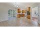 Open kitchen with stainless steel appliances, lots of cabinets, and access to a screened-in porch at 5256 Mulholland Dr, Summerville, SC 29485