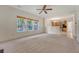 Spacious living room with natural light and neutral carpet, with kitchen view and wood blinds at 5256 Mulholland Dr, Summerville, SC 29485
