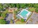 Aerial image of a vibrant community pool area, lush landscaping, a playground and ample parking at 5256 Mulholland Dr, Summerville, SC 29485
