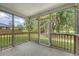 Inviting screened porch with a view of the lush backyard and pond, perfect for relaxation at 5256 Mulholland Dr, Summerville, SC 29485