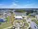 Aerial view showcasing a community with a central lake, pool, playground, and well-maintained landscaping at 528 Fern Tree Dr, Summerville, SC 29486