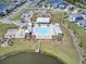 An aerial view reveals the community's amenities, including a pool, playground, and lake with a pier at 528 Fern Tree Dr, Summerville, SC 29486