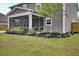 Backyard view with screened-in porch and beautiful landscaping at 528 Fern Tree Dr, Summerville, SC 29486