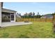 Grassy backyard with concrete patio and firepit at 528 Fern Tree Dr, Summerville, SC 29486