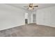 Large bedroom with a ceiling fan, neutral carpet, ensuite bathroom, and white trim at 528 Fern Tree Dr, Summerville, SC 29486