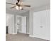 Bedroom with double doors to closet, ensuite bathroom, neutral carpet and ceiling fan at 528 Fern Tree Dr, Summerville, SC 29486