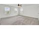 Airy bedroom with large windows, a ceiling fan, and neutral carpeting at 528 Fern Tree Dr, Summerville, SC 29486