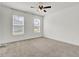 This bright bedroom has two windows and a ceiling fan at 528 Fern Tree Dr, Summerville, SC 29486