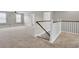 Open bonus room boasts modern staircase, plush carpeting, and abundant space for versatile living at 528 Fern Tree Dr, Summerville, SC 29486