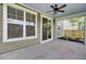 Cozy covered patio with a ceiling fan, sliding glass door, and manicured landscaping at 528 Fern Tree Dr, Summerville, SC 29486