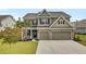 Charming two-story home featuring a brick facade, a well-manicured lawn and a spacious driveway at 528 Fern Tree Dr, Summerville, SC 29486