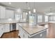 Bright kitchen with stainless steel appliances, stone countertops, kitchen island, and sliding glass doors leading to the patio at 528 Fern Tree Dr, Summerville, SC 29486