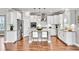 This modern kitchen boasts white cabinets, stainless steel appliances, and a granite island with seating at 528 Fern Tree Dr, Summerville, SC 29486