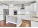 Modern kitchen featuring white cabinets, stainless steel appliances, and a spacious island with a light colored countertop at 528 Fern Tree Dr, Summerville, SC 29486
