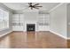 Living room features a fireplace, wood floors, a ceiling fan, and built-in shelving at 528 Fern Tree Dr, Summerville, SC 29486