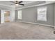 Spacious main bedroom boasting a tray ceiling, abundant natural light, plush carpet, and calming paint at 528 Fern Tree Dr, Summerville, SC 29486