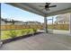 Screened-in porch with a view of the backyard and neighboring houses, offering a comfortable outdoor space at 528 Fern Tree Dr, Summerville, SC 29486