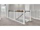 Bright staircase with white railings and wooden handrail leads to the upper level of the house at 528 Fern Tree Dr, Summerville, SC 29486