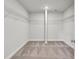Spacious walk-in closet featuring neutral carpet, center column and shelves on all walls at 528 Fern Tree Dr, Summerville, SC 29486