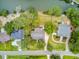 Aerial view of a neighborhood with homes nestled among lush trees near a waterfront at 634 Lynne Ave, Charleston, SC 29412