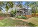 Expansive backyard with a multi-level deck, lush greenery, well-maintained lawn, and a privacy fence at 634 Lynne Ave, Charleston, SC 29412