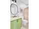 Stylish bathroom featuring a green vanity with granite countertop, round mirror, and a shower with curtain at 634 Lynne Ave, Charleston, SC 29412