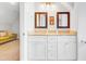 Bathroom with double vanity, granite countertops and decorative framed mirrors at 634 Lynne Ave, Charleston, SC 29412