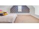 Bright bedroom featuring a cozy queen bed, patterned accent wall, and plenty of natural light at 634 Lynne Ave, Charleston, SC 29412