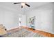 Airy bedroom with hardwood floors, a ceiling fan, a geometric patterned rug, and white walls for a modern aesthetic at 634 Lynne Ave, Charleston, SC 29412