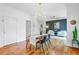 Dining room with modern lighting, dark accent wall, hardwood floors, and seating for six at 634 Lynne Ave, Charleston, SC 29412