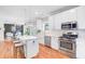 Modern kitchen with stainless steel appliances, white cabinets, an island, and bar stool seating at 634 Lynne Ave, Charleston, SC 29412