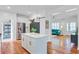 Bright kitchen featuring stainless steel appliances, island with bar stools, and open access to the living room at 634 Lynne Ave, Charleston, SC 29412