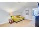 Cozy living room featuring an olive-green sofa, side table with lamp, and access to a bedroom, creating a relaxing space at 634 Lynne Ave, Charleston, SC 29412
