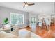 Bright living room with hardwood floors, decorative sitting chairs, natural light, and easy access to kitchen at 634 Lynne Ave, Charleston, SC 29412