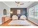 Inviting living room featuring modern ceiling fan, natural light, and stylish accent wall, creating a comfortable atmosphere at 634 Lynne Ave, Charleston, SC 29412