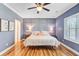 Serene main bedroom featuring a stylish accent wall, ceiling fan, and ample natural light, providing a relaxing retreat at 634 Lynne Ave, Charleston, SC 29412