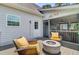Outdoor deck with a fire pit, comfortable chairs, and a serene view of the adjacent property and foliage at 634 Lynne Ave, Charleston, SC 29412