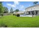 Spacious backyard featuring a pool, a covered patio, and a well-manicured lawn at 7164 Sweetgrass Blvd, Hanahan, SC 29410