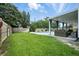 Spacious backyard featuring a pool, a covered patio, and a well-manicured lawn at 7164 Sweetgrass Blvd, Hanahan, SC 29410