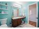 Bright bathroom featuring a floating vanity, modern lighting, and elegant marble flooring at 7164 Sweetgrass Blvd, Hanahan, SC 29410