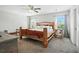 Bedroom featuring a rustic wooden bed frame, ceiling fan, and neutral colored walls at 7164 Sweetgrass Blvd, Hanahan, SC 29410