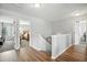 Upstairs hallway featuring wood floors and access to bedrooms at 7164 Sweetgrass Blvd, Hanahan, SC 29410
