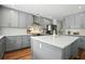 Modern kitchen featuring gray cabinets, stainless steel appliances, and a quartz countertop island at 7164 Sweetgrass Blvd, Hanahan, SC 29410
