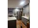 This open kitchen features an island, stainless steel appliances and ample counter space at 7164 Sweetgrass Blvd, Hanahan, SC 29410