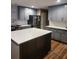 This updated kitchen boasts an island, plentiful countertop space, stainless steel appliances and wooden flooring at 7164 Sweetgrass Blvd, Hanahan, SC 29410