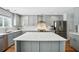 Contemporary kitchen featuring gray cabinetry, stainless steel appliances, and a large center island with quartz countertops at 7164 Sweetgrass Blvd, Hanahan, SC 29410